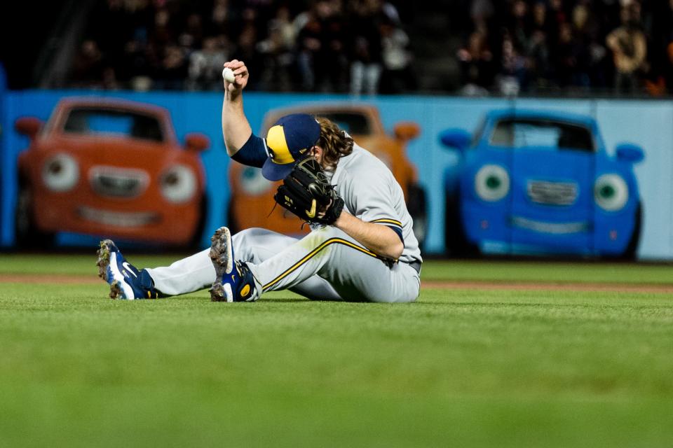 Brewers starting pitcher Corbin Burnes reacts after he missed fielding a comebacker, allowing a run for the Giants during the fifth inning Friday night at Oracle Park.