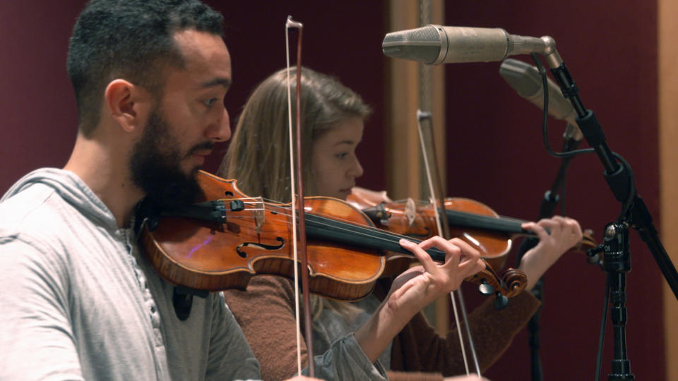 In this Nov. 7, 2018, photo provided by the University of Michigan, student violinists Reuben Kebede and Dana Johnson perform at a recording session in Ann Arbor, Mich., with Contemporary Directions Ensemble recording "The Most Beautiful Time of Life," as it's translated from German to English. The music has not been heard since it was arranged and performed by prisoners in a World War II death camp. The ensemble will perform the piece Friday, Nov. 30, 2018, during a free on-campus concert. The handwritten manuscript was discovered by university music theory professor Patricia Hall while doing research at the Auschwitz-Birkenau Museum in Poland. (Christopher Boyes/University of Michigan via AP)