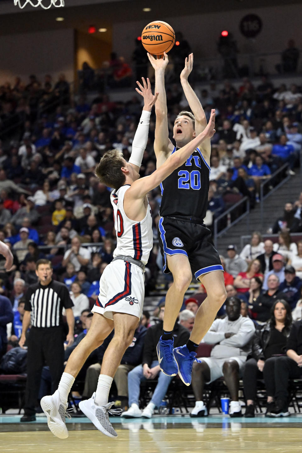 BYU guard Spencer Johnson (20) shoots against Saint Mary's guard Aidan Mahaney during the second half of an NCAA college basketball game in the semifinals of the West Coast Conference men's tournament Monday, March 6, 2023, in Las Vegas. (AP Photo/David Becker)