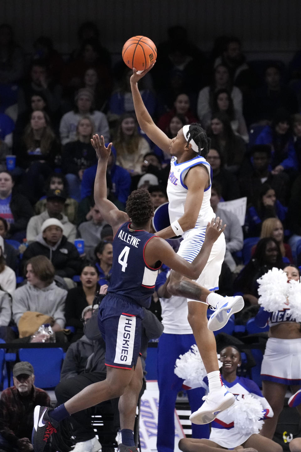 DePaul's Javan Johnson scores over Connecticut's Nahiem Alleyne during the first half of an NCAA college basketball game Tuesday, Jan. 31, 2023, in Chicago. (AP Photo/Charles Rex Arbogast)