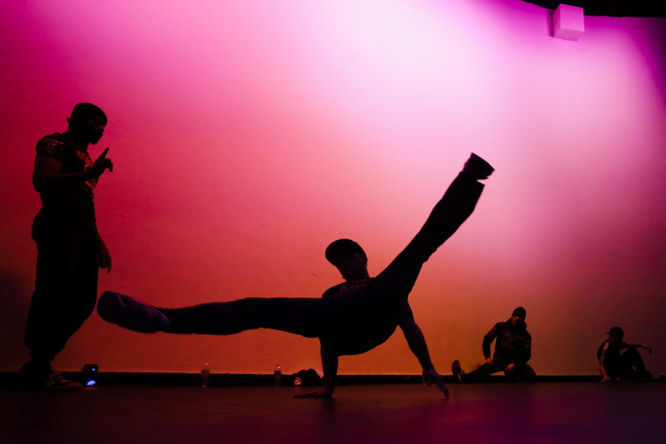 Bboy Curca "Bugy" Bogdan, center, of Romania, warms up with others before the World Bboy Battle Saturday, Dec. 21, 2019, in New York. Many in the breaking community are eager for the art form to expand its audience after the International Olympic Committee announced that it would become an official sport at the Paris 2024 games. But that optimism is hardly unanimous. (AP Photo/Frank Franklin II)