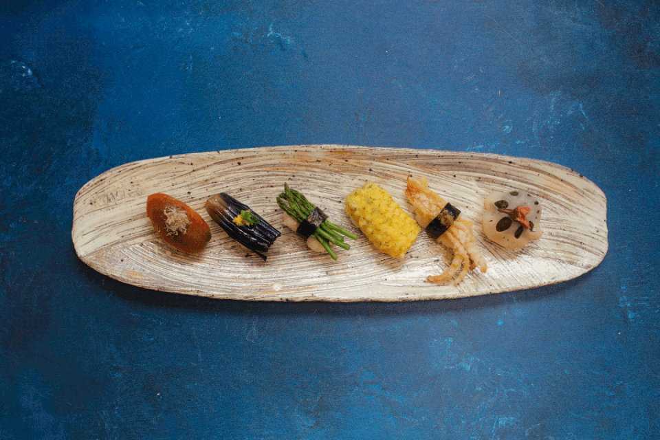 A platter holds a selection of vegan sushi.