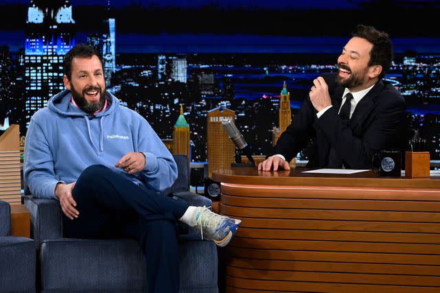 <p>Todd Owyoung/NBC/Getty </p> Adam Sandler during an interview with host Jimmy Fallon in 2022