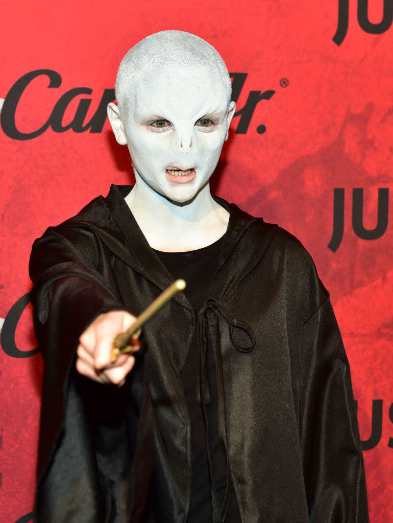 Joey posing on the red carpet with a wand