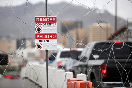 A warning sign is pictured on a serpentine wire blocking a lane towards El Paso, Texas, U.S. on the international border bridge Paso del Norte, as seen from Ciudad Juarez