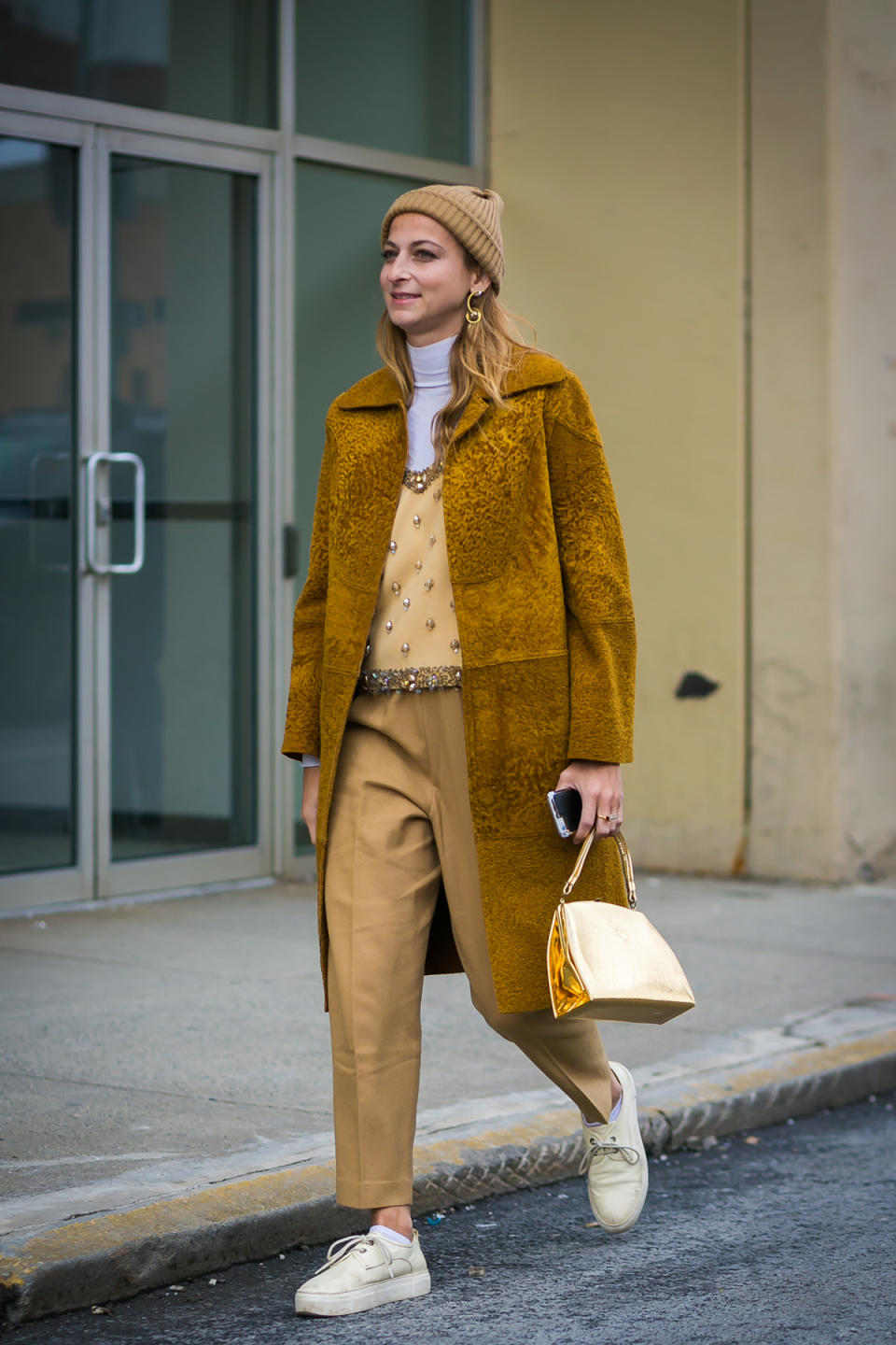 Annie Georgia Greenberg in golden layers at New York Fashion Week.