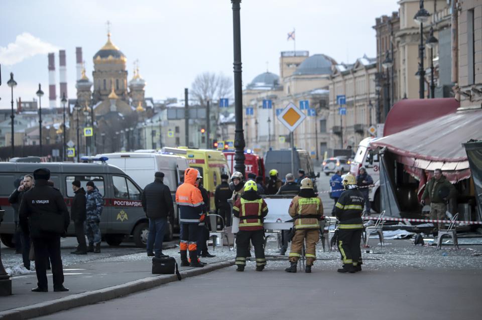 Russian Emergency Situations Ministry stand at the side of an explosion at a cafe in St. Petersburg, Russia, Sunday, April 2, 2023. An explosion tore through a cafe in the Russian city of St. Petersburg on Sunday, and preliminary reports suggested a prominent military blogger was killed and more than a dozen people were injured. (AP Photo)
