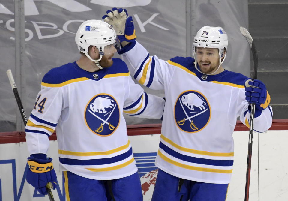 Buffalo Sabres center Rasmus Asplund (74) celebrates his goal with Buffalo Sabres defenseman Matthew Irwin (44) during the third period of an NHL hockey game Tuesday, Feb. 23, 2021, in Newark, N.J. The Sabres won 4-1.(AP Photo/Bill Kostroun)