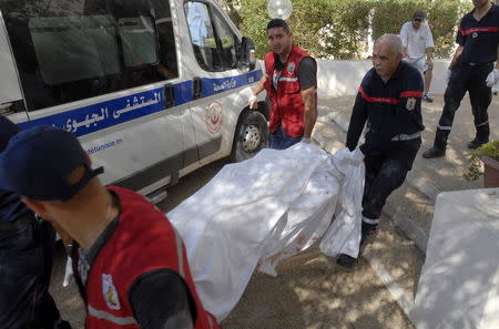 Rescuers carry the body of a tourist who was shot dead by a gunman at a beachside hotel in Sousse, Tunisia, June 26, 2015. REUTERS/Amine Ben Aziza