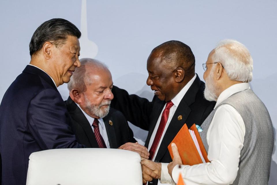 President of China Xi Jinping and Indian Prime Minister of India Narendra Modi gesture during the 2023 Brics (AFP via Getty Images)