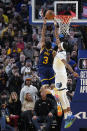 Golden State Warriors guard Jordan Poole, left, scores the game-winning basket next to Memphis Grizzlies guard Ziaire Williams during the second half of an NBA basketball game in San Francisco, Wednesday, Jan. 25, 2023. (AP Photo/Godofredo A. Vásquez)