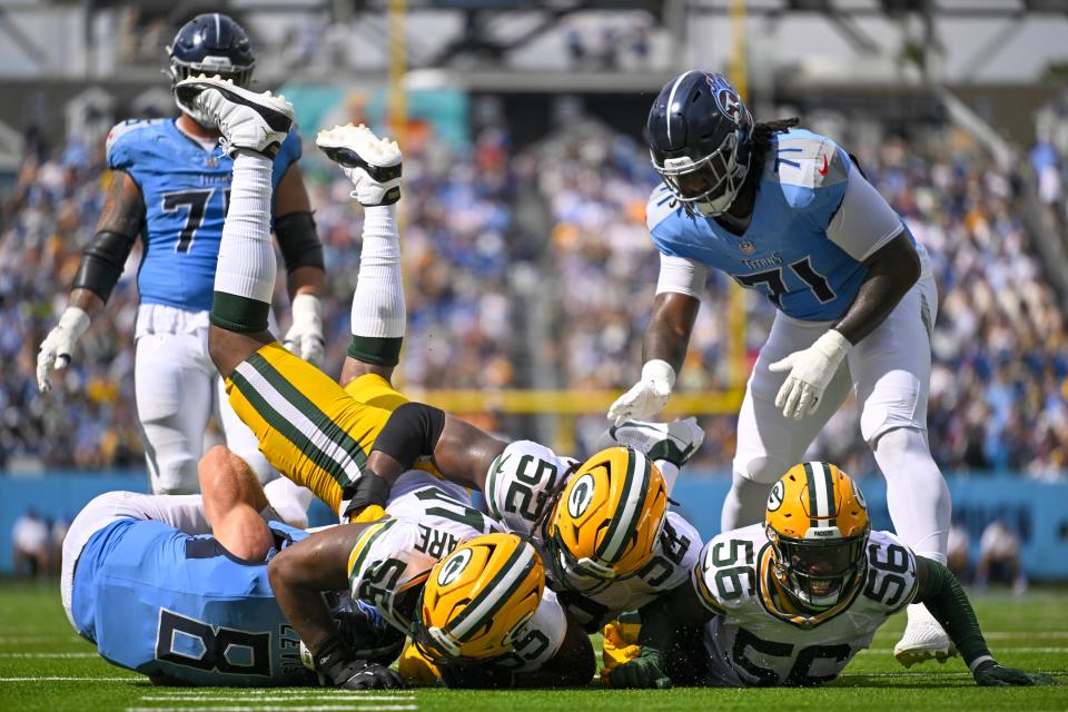 Tennessee Titans' Will Levis is sacked by Green Bay Packers' Kingsley Enagbare (55), Rashan Gary (52) and Edgerrin Cooper (56) during the second half of an NFL football game Sunday, Sept. 22, 2024, in Nashville, Tenn. (AP Photo/John Amis)