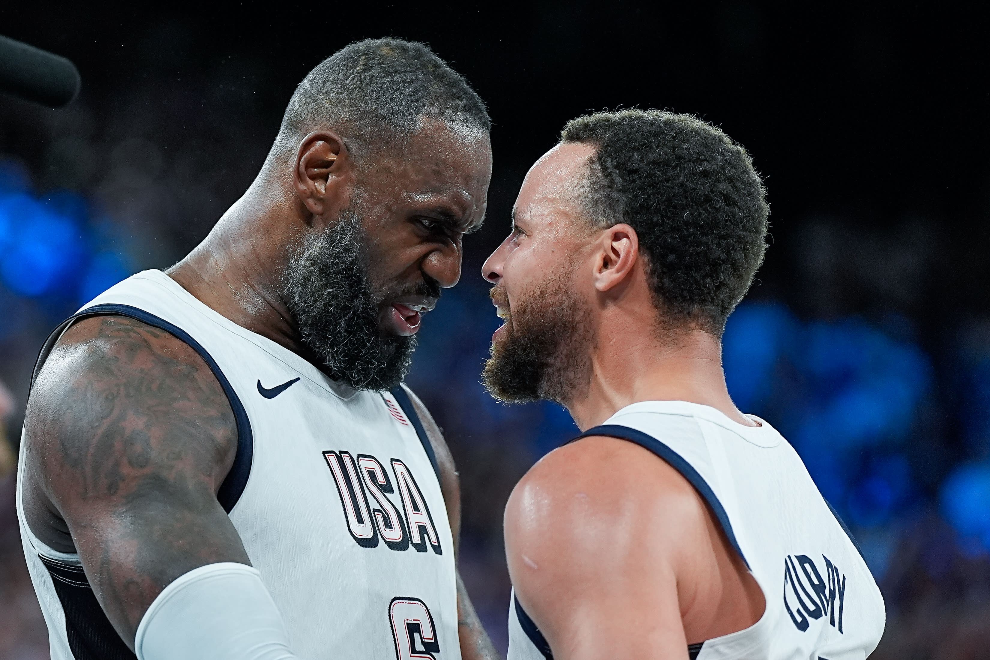 Lebron James of the United States and Stephen Curry of the United States celebrate their victory and advancement to the final at the final whistle during the men's semifinal match between the United States and Serbia on the thirteenth day of the Paris 2024 Olympic Games at Arena Bercy on August 8, 2024 in Paris, France. (Daniela Porcelli/Eurasia Sport Images/Getty Images)