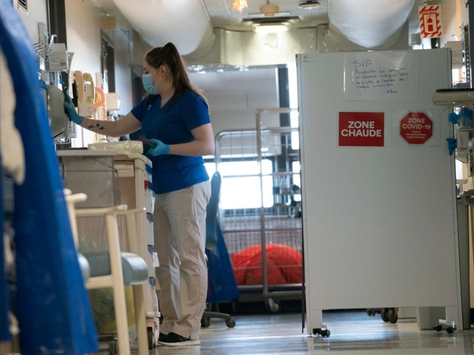 An attendant cleans equipment at Jean-Talon Hospital in Montreal. The Quebec government is asking workers to opt-in to work in a hospital setting as service aides. (CBC / Radio-Canada - image credit)