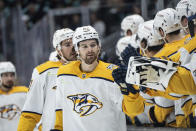 Nashville Predators forward Tommy Novak celebrates with teammates on the bench after scoring a goal against the Seattle Kraken during the first period of an NHL hockey game, Saturday, March 16, 2024, in Seattle. (AP Photo/Stephen Brashear)