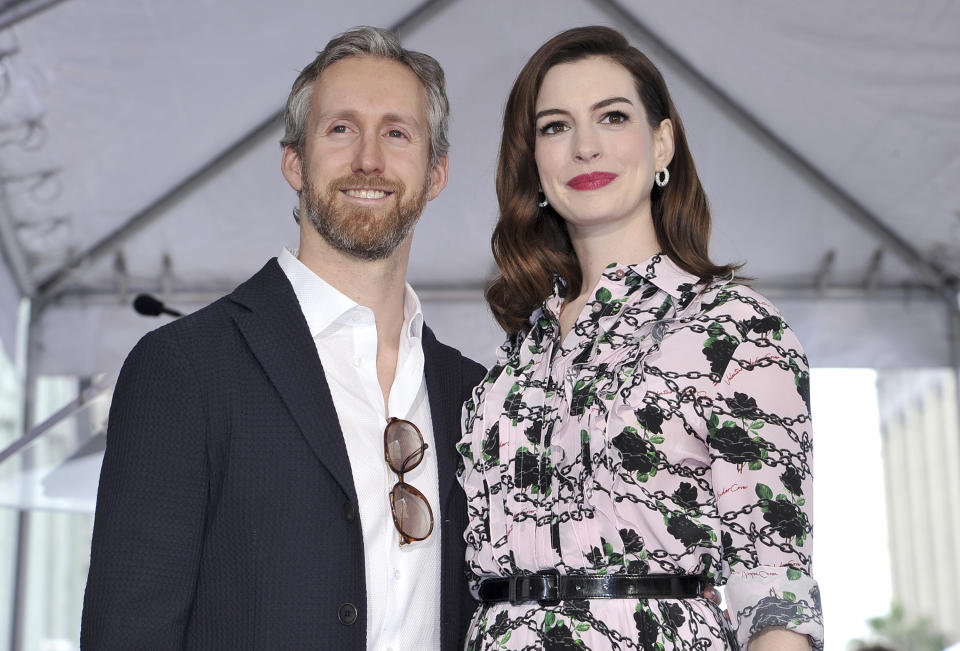 FILE - This May 9, 2019 file photo shows actress Anne Hathaway, right, and her husband Adam Shulman at a ceremony honoring Hathaway with a star on the Hollywood Walk of Fame in Los Angeles. Hathaway announced Wednesday, July 24, on her Instagram account that she and husband are expecting their second child. (Photo by Richard Shotwell/Invision/AP, File)