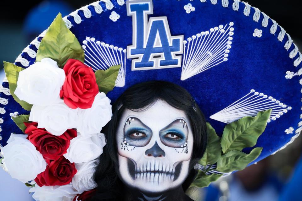 La Muerta Maria wears a Dodger's sombrero before the game