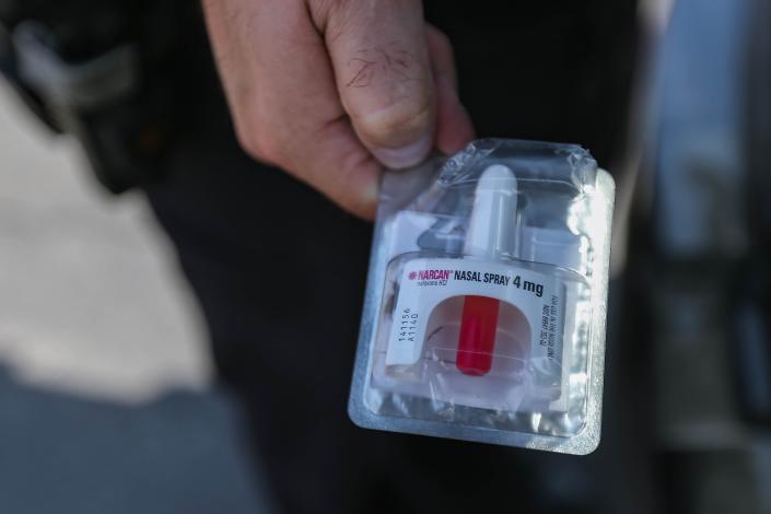 Oklahoma City police officer Sgt. Dustin Wright shows a packaged Narcan nasal spray on Aug. 9, 2022. Wright gives Narcan nasal spray to hotel clerks in case of an overdose of a guest.