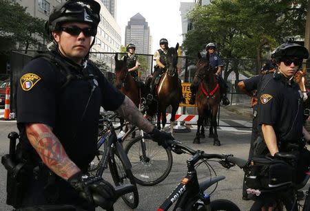 Police on bicycle and horseback block a downtown street during a march by various groups, including "Black Lives Matter" and "Shut Down Trump and the RNC" ahead of the Republican National Convention in Cleveland, Ohio, U.S. July 17, 2016. REUTERS/Lucas Jackson