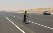 Egyptian cyclist Helmy El Saeed, 27, rides his bicycle during training on the highway of El Ain El Sokhna, east of Cairo, Egypt July 19, 2017. El Saeed has become a Guinness record holder after partaking in the fastest ever Europe bicycle cross. Picture taken July 19, 2017. REUTERS/Amr Abdallah Dalsh
