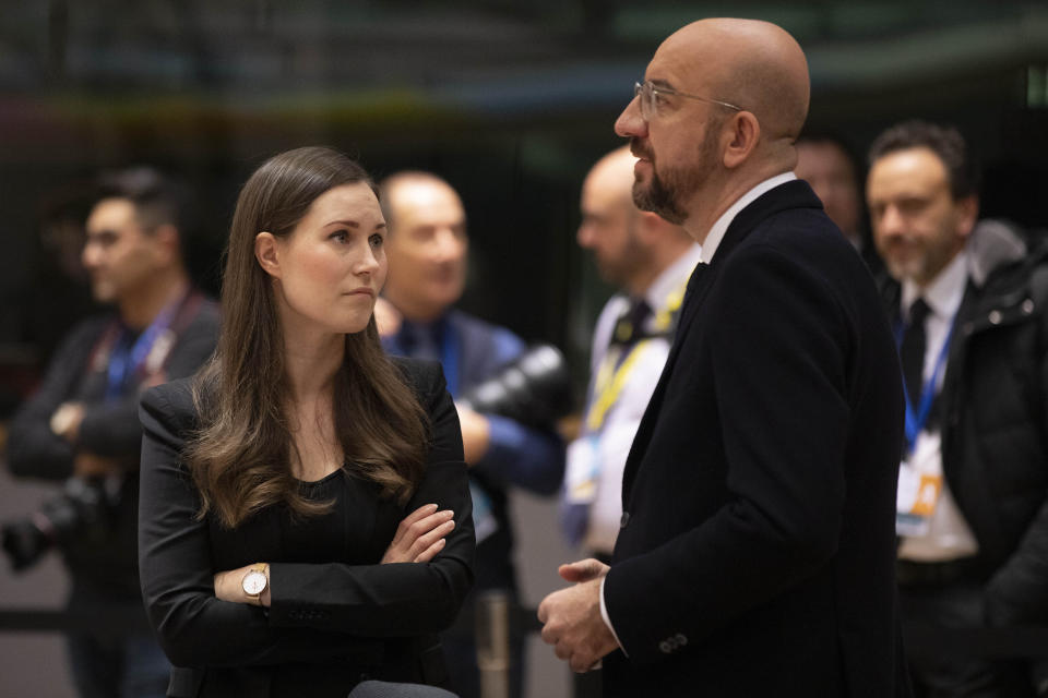 Finnish Prime Minister Sanna Marin, left, speaks with European Council President Charles Michel during a round table meeting at an EU summit in Brussels, Friday, Dec. 13, 2019. European Union leaders are gathering Friday to discuss Britain's departure from the bloc amid some relief that Prime Minister Boris Johnson has secured an election majority that should allow him to push the Brexit deal through parliament. (AP Photo/Olivier Matthys)