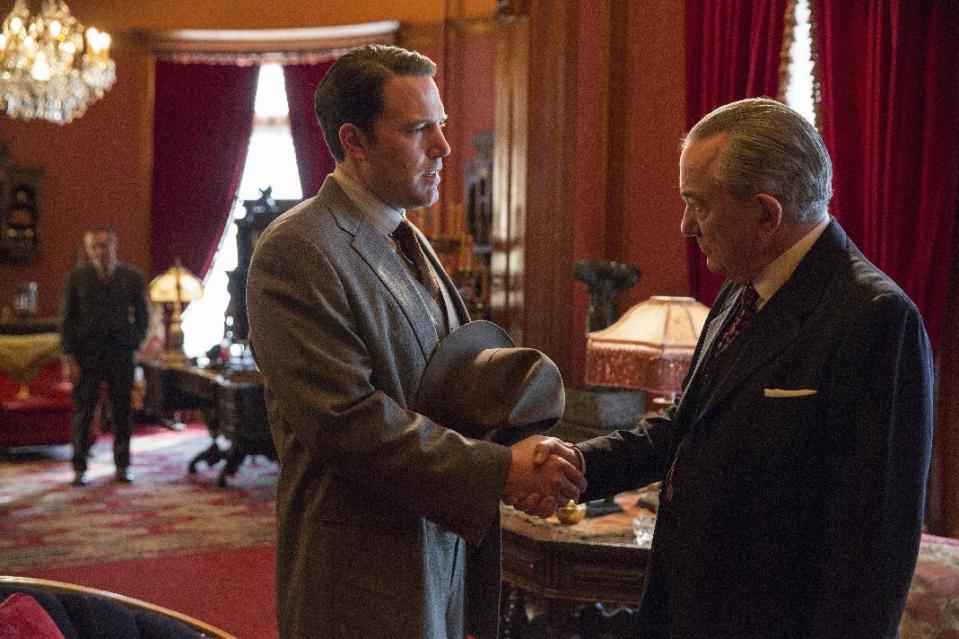 This image released by Warner Bros. Entertainment shows Ben Affleck, left, and Remo Girone in a scene from "Live By Night." (Claire Folger/Warner Bros. Entertainment via AP)