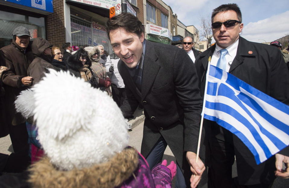 Prime Minister Justin Trudeau greets a member of the crowd as he attends the Greek Independence Day parade in Montreal, Sunday, April 3, 2016. THE CANADIAN PRESS/Graham Hughes