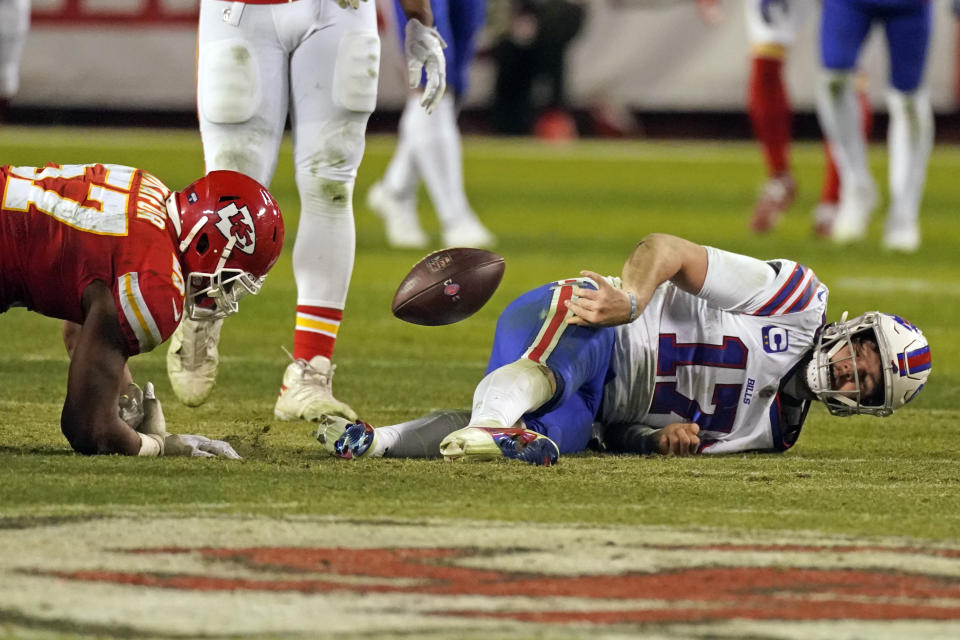 Buffalo Bills quarterback Josh Allen (17) tosses the ball towards Kansas City Chiefs defensive end Alex Okafor (57) after being sacked during the second half of the AFC championship NFL football game Sunday, Jan. 24, 2021, in Kansas City, Mo. (AP Photo/Charlie Riedel)