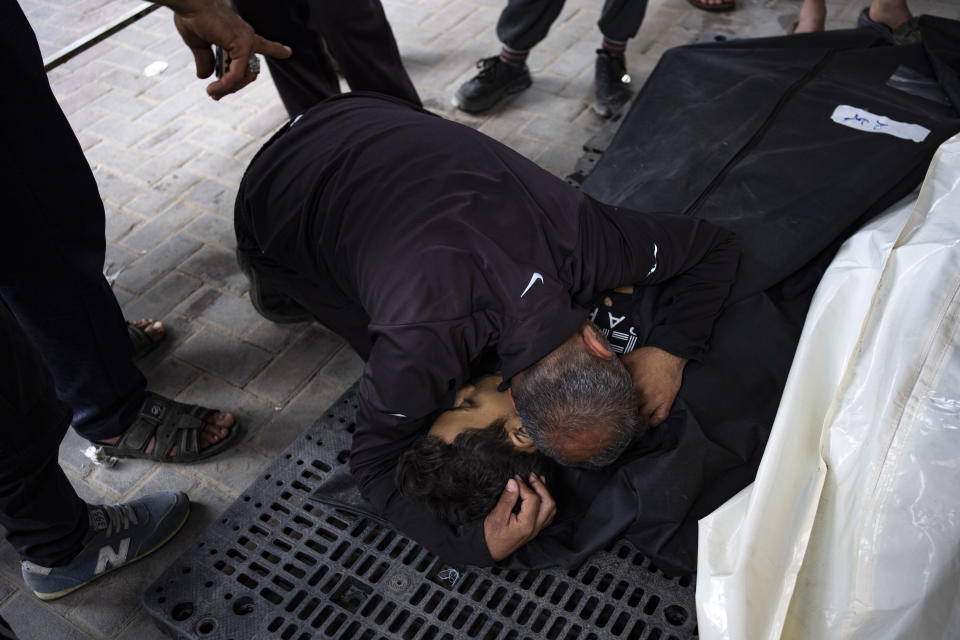 Palestinians mourn relatives killed in the Israeli bombardment of the Gaza Strip at a hospital morgue in Rafah, Monday, April 1, 2024. (AP Photo/Fatima Shbair)