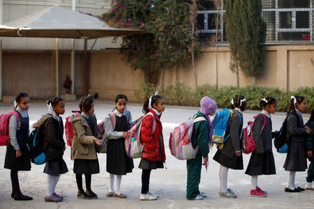 Girls stand in line to board a bus to transport them to school from an orphanage in Sanaa, Yemen, December 26, 2016. REUTERS/Khaled Abdullah