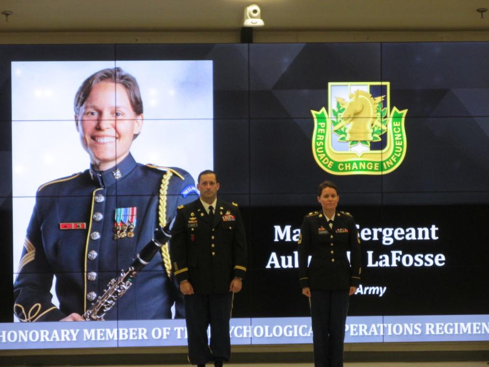 Master Sgt. Aubrey LaFosse is welcomed by Lt. Col. Jeffrey Souther as an honorary member of the psychological operations regiment during a Nov. 4, 2021, ceremony at Fort Bragg.