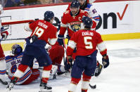 Florida Panthers center Aleksander Barkov (16), left wing Matthew Tkachuk (19) and defenseman Aaron Ekblad (5) celebrate after scoring against New York Rangers goaltender Jaroslav Halak (41) during the first period of an NHL hockey game Saturday, March 25, 2023, in Sunrise, Fla. (AP Photo/Rhona Wise)