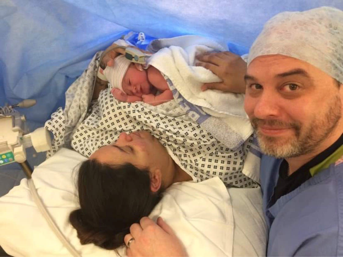 A couple who tried to conceive for 18 years have welcomed two more babies via IVF, Kim and James with baby Harrison shortly after his birth. (Kim Barrett/SWNS)