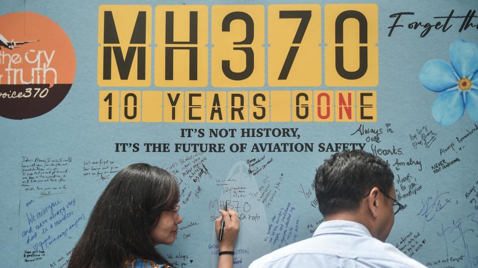 PHOTO: A woman writes a message on March 3, 2024, during an event held by relatives of the passengers and supporters to mark the 10th year since the Malaysia Airlines flight MH370 disappeared from radar screens on March 8, 2014. (Arif Kartono/AFP via Getty Images)