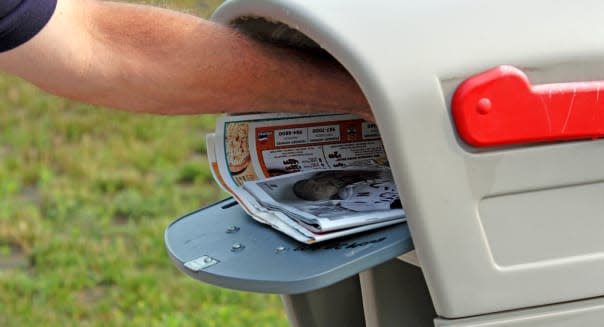 Collecting the usual junk mail from your postbox, this man checks through his mail.