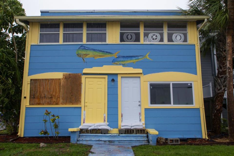 Sandbags guard a colorful building in St. Petersburg as Hurricane Idalia approaches the area.