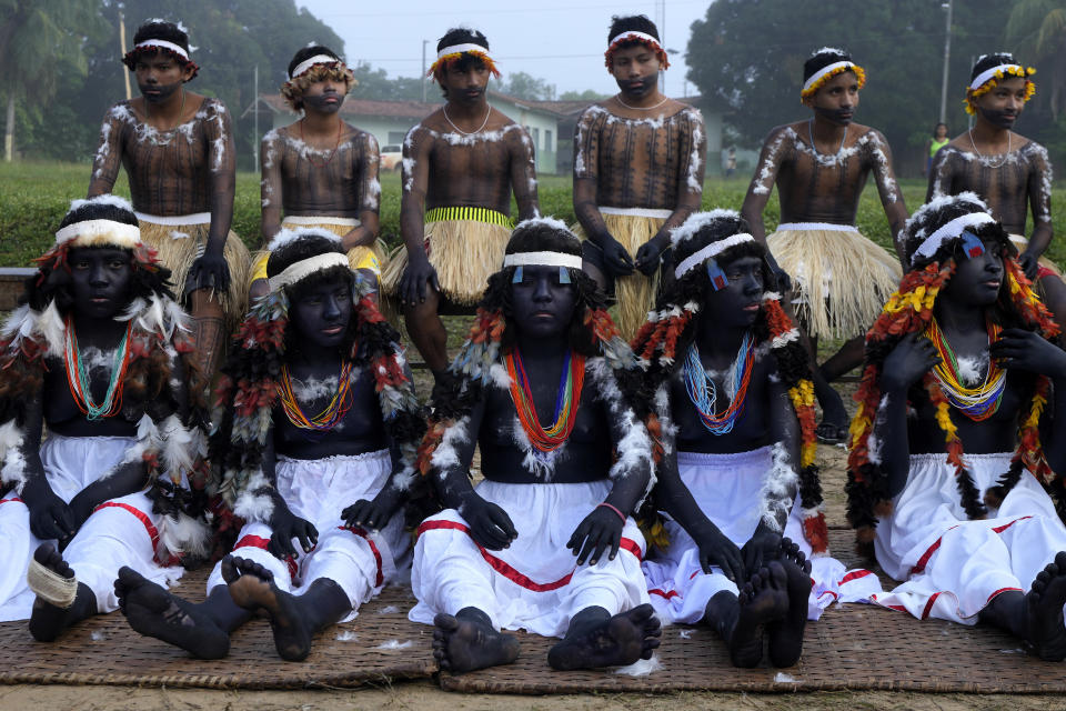 Indigenous girls and boys prepare to take part of a ritual during the final and most symbolic day of the Wyra'whaw coming-of-age festival at the Ramada ritual center, in the Tenetehar Wa Tembe village, located in the Alto Rio Guama Indigenous territory in Para state, Brazil, Sunday, June 11, 2023. (AP Photo/Eraldo Peres)