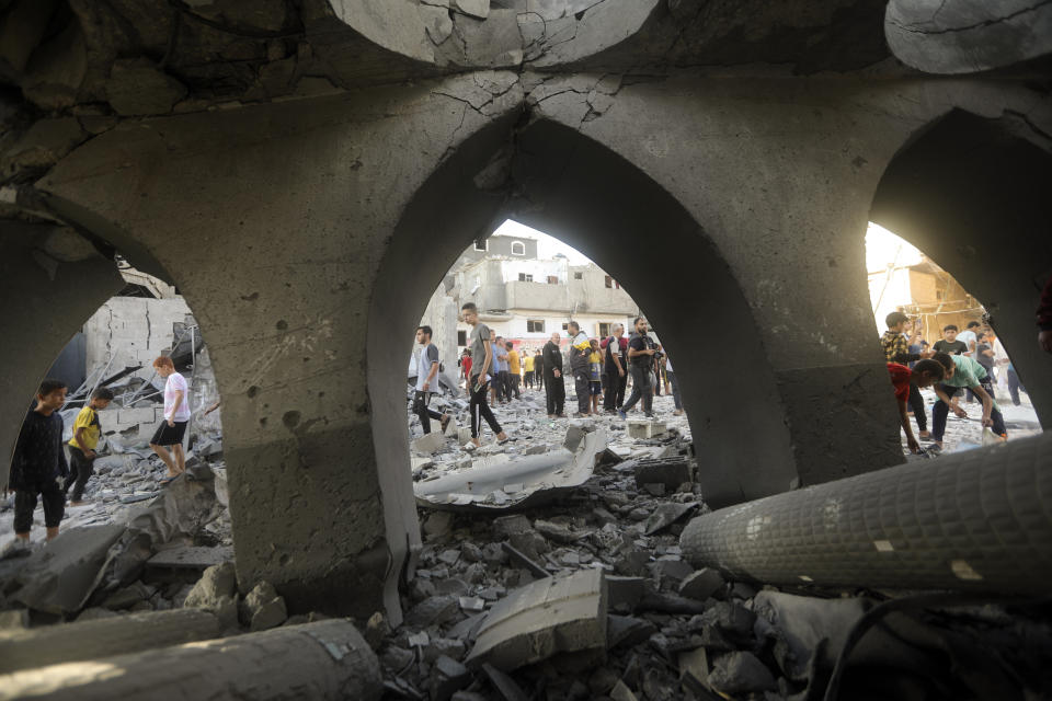 Palestinians inspect the damage of a destroyed mosque following an Israeli airstrike in Khan Younis refugee camp, southern Gaza Strip, Wednesday, Nov. 8, 2023. (AP Photo/Mohammed Dahman)