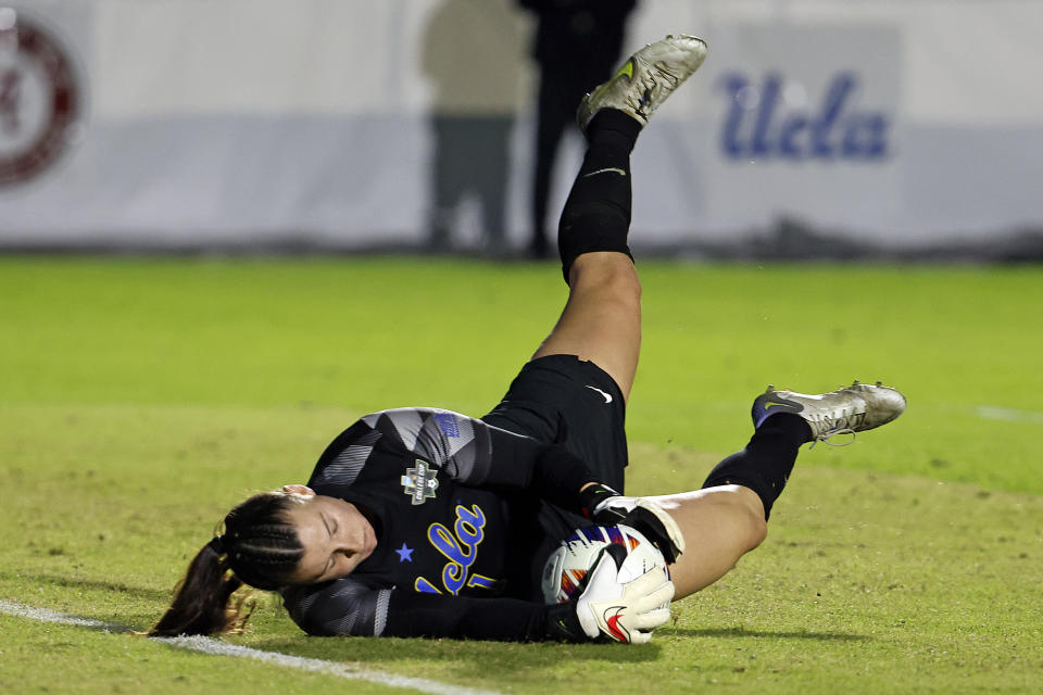 UCLA goalkeeper Lauren Brzykcy stops an Alabama shot during the first half of an NCAA women's soccer tournament semifinal in Cary, N.C., Friday, Dec. 2, 2022. (AP Photo/Karl B DeBlaker)