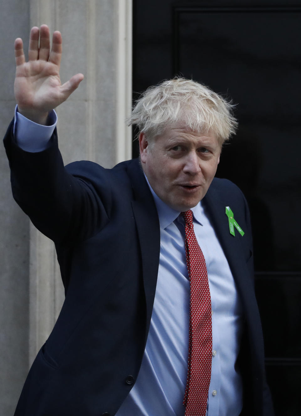 Britain's Prime Minister Boris Johnson waves to the media from the doorstep of 10 Downing Street in London, Thursday, Oct. 10, 2019, ahead of meeting mental health campaigners. (AP Photo/Alastair Grant)