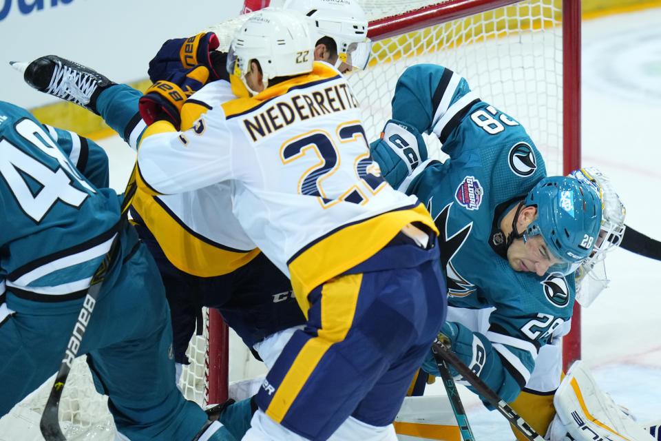 Nashville's Nino Niederreiter, left, checks San Jose's Timo Meier during the NHL hockey game between San Jose Sharks and Nashville Predators played in Prague, Czech Republic, Saturdday, Oct. 8, 2022. (AP Photo/Petr David Josek)