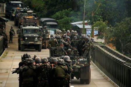 Philippines army soldiers ride in trucks into the fighting zone as government troops continue their assault against insurgents from the Maute group in Marawi City, Philippines June 28, 2017. REUTERS/Jorge Silva