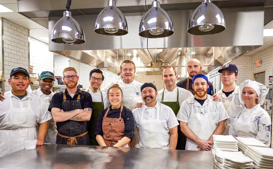 Oak and Reel's 2023 Culinary Collective welcomed students enrolled in culinary programs at Oakland Community College and Henry Ford College to cook alongside Michelin-starred chef Michael White (back center) as well as Oak and Reel's team of chefs.