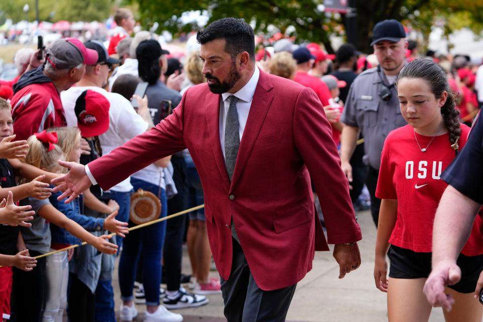 Sep 16, 2023; Columbus, Ohio, USA; Ohio State Buckeyes head coach Ryan Day high fives fans as he walks into Ohio Stadium for the NCAA football game against the Western Kentucky Hilltoppers.