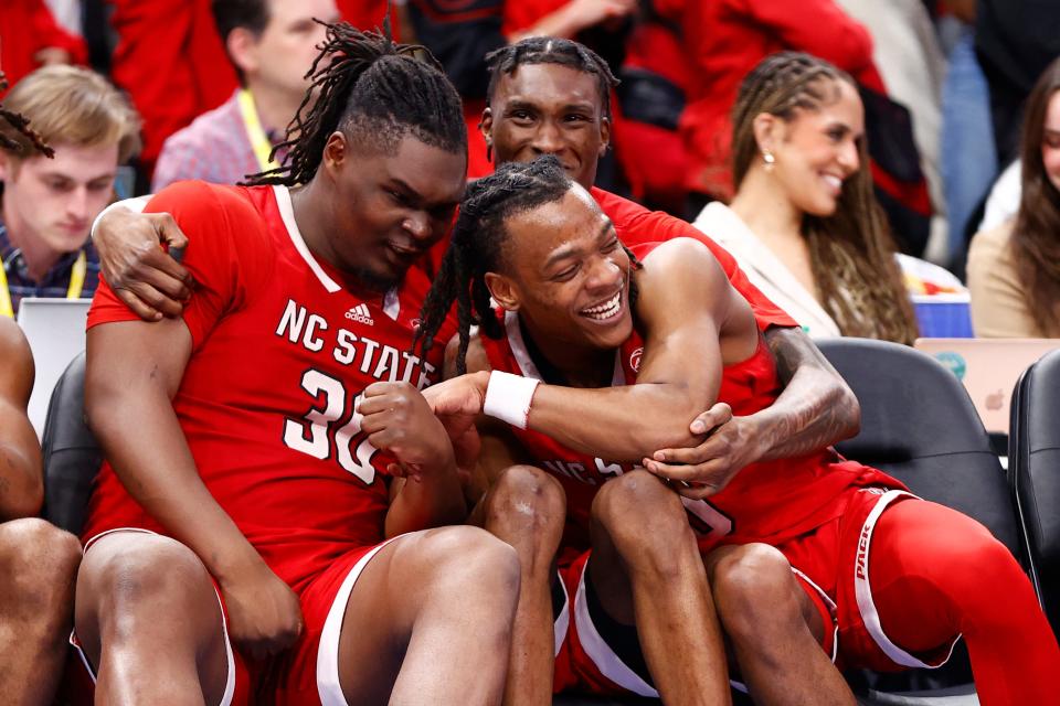 North Carolina State Wolfpack forward DJ Burns Jr. (30) and guard DJ Horne (0) react on the bench during the second half at Capital One Arena.