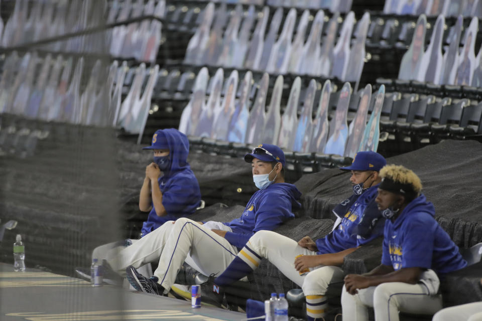 Seattle Mariners pitcher Yusei Kikuchi, second from left, sits with teammates above the dugout during the first inning of a baseball game against the Oakland Athletics, Sunday, Aug. 2, 2020, in Seattle. (AP Photo/Ted S. Warren)