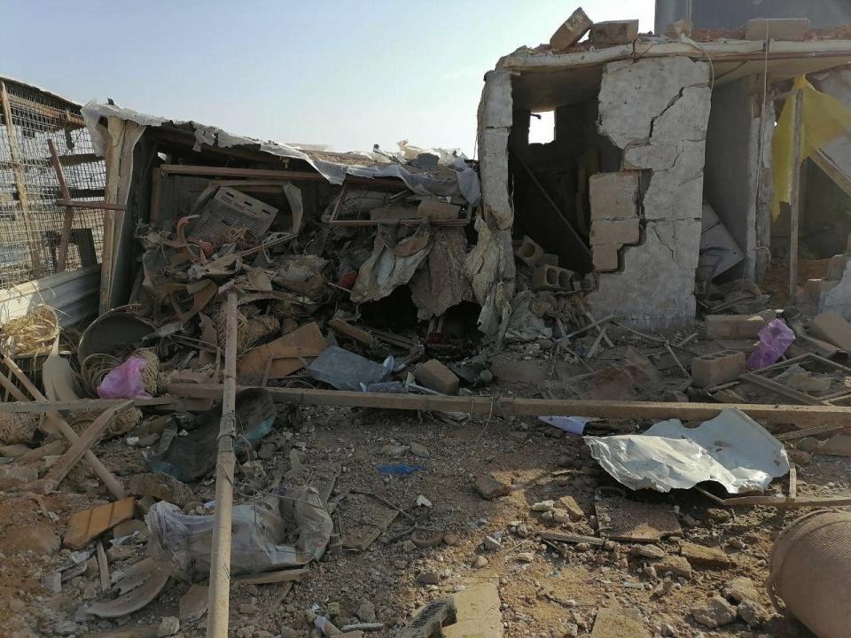 The headquarters of Kataeb Hezbollah, or Hezbollah Brigades militia, lies in ruins in the aftermath of a U.S. airstrike in Qaim, Iraq, Monday, Dec. 30, 2019. The Iranian-backed militia said Monday that the death toll from U.S. military strikes in Iraq and Syria against its fighters has risen to 25, vowing to exact revenge for the "aggression of evil American ravens." (AP Photo)
