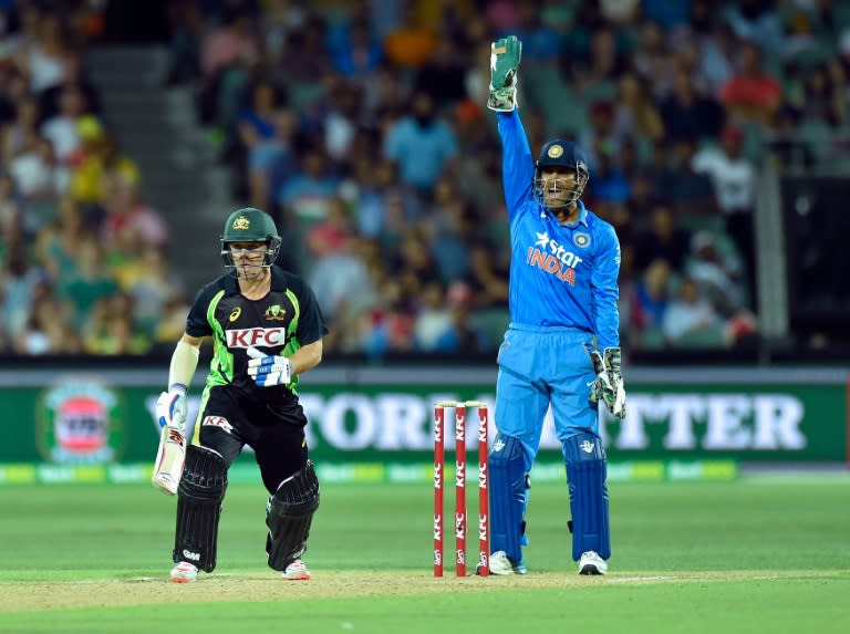 M. S. Dhoni of India (R) appeals for the dismissal of Travis Head of Australia during their Twenty20 match in Adelaide, in January 2016