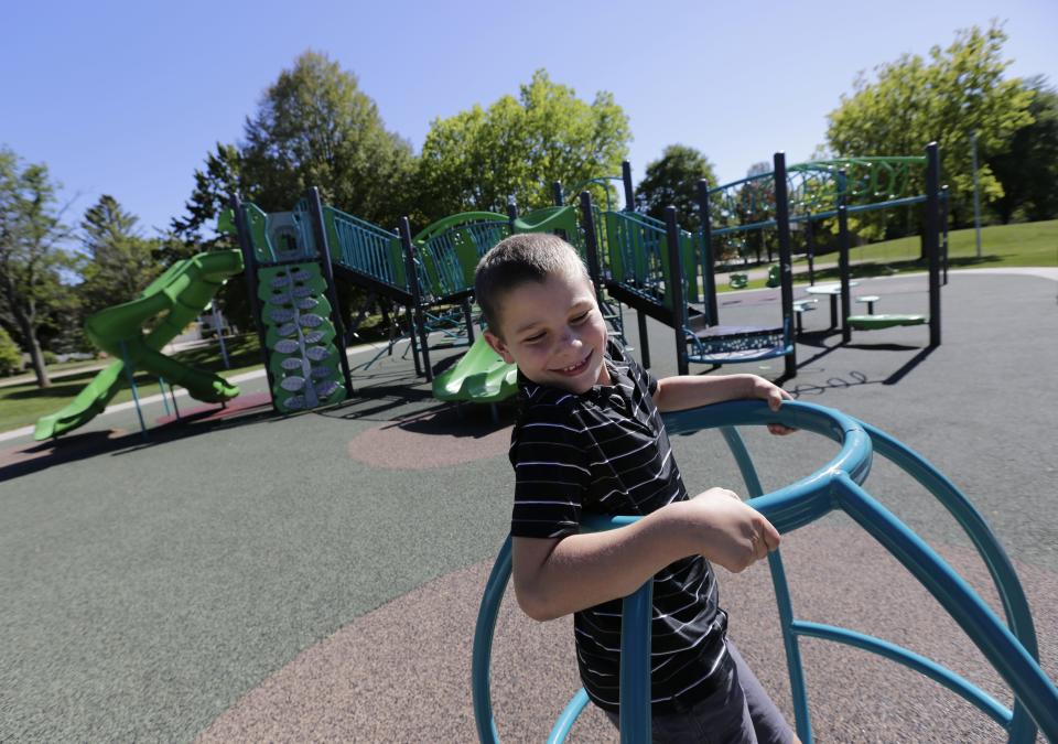 Teddy Blondheim, 10, enjoys using playground equipment last August at Westhaven Circle Park in Oshkosh. Teddy has a rare genetic disorder, PIGN-CDG, that affects every aspect of his functioning, including his gross motor skills and speech. He struggles at playgrounds that don't have accessible features but has gotten more capable as he has gotten older. Teddy's mother, Kerry, says they like playgrounds with accessible features so he can play with all the kids.