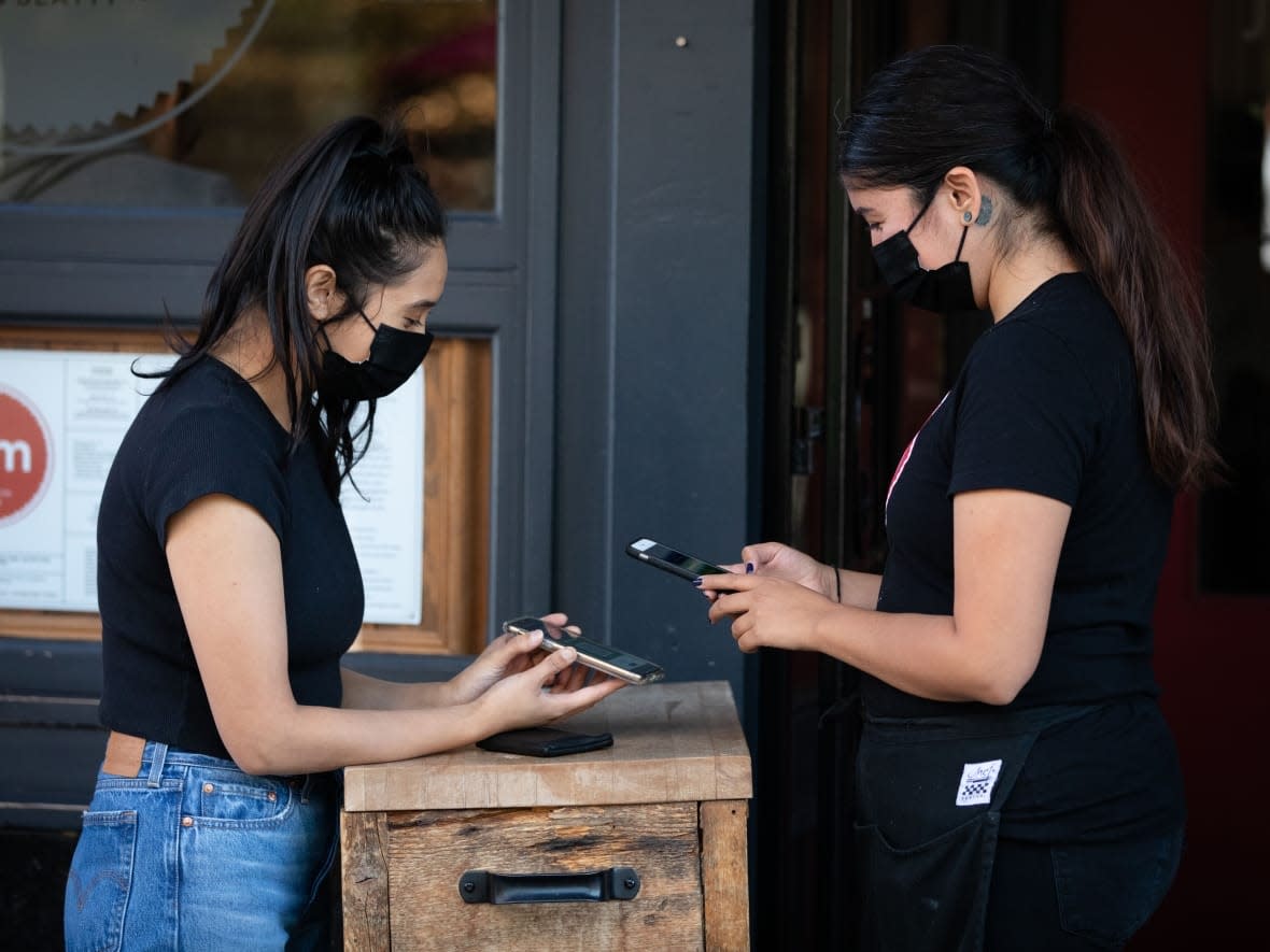 A vaccine card is scanned outside of Jam Cafe in Vancouver, B.C. on Wednesday, September 15, 2021. (Maggie MacPherson/CBC - image credit)